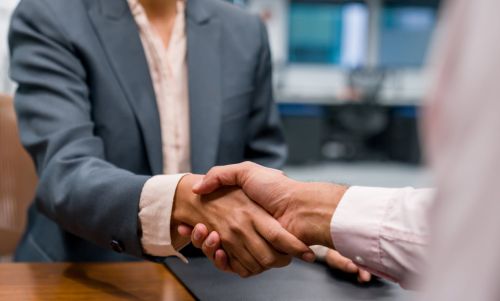 Close-up on business people closing a deal with a handshake at the office. Concept for How to Select the Right California Probate Lawyer.
