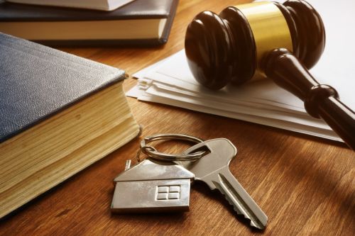 Key from real estate and gavel. Commonly Litigated Issues in Real Estate concept