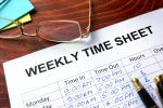 Paper with employee's weekly time sheet hours listed on a table. Concept for California Employers Protect Themselves from Wage and Hour Claims.