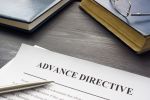 Medical Advance Healthcare directive form and book with glasses.